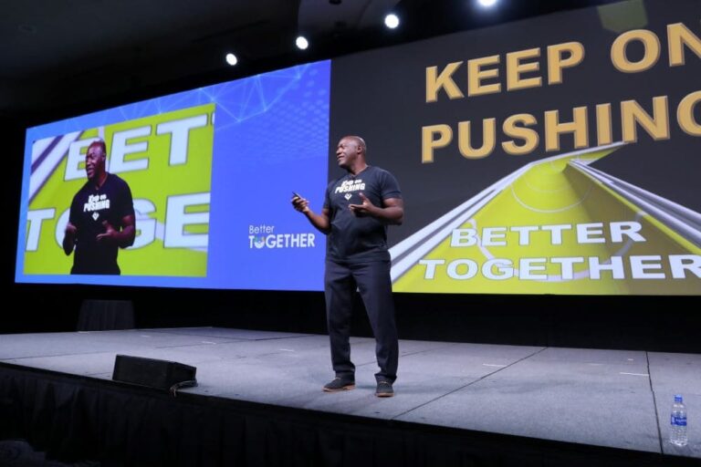 Devon Harris on stage at a conference general session