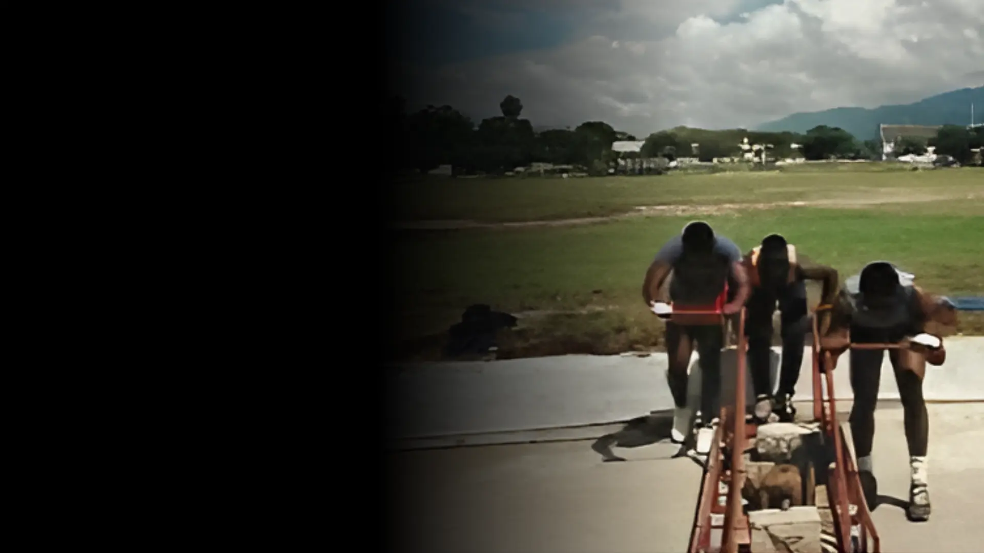 Jamaican bobsled athletes practicing the push start on a wheeled training sled in Jamaica
