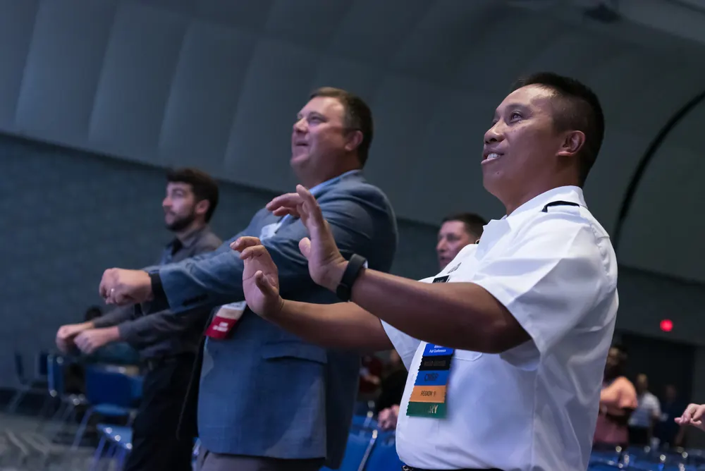 Audience members joining an interactive exercise during Devon Harris's inclusion keynote